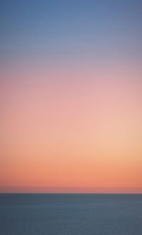 Scenic view of sea against romantic sky at sunset