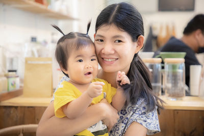 Portrait of mother holding girl