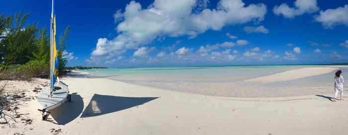 Scenic view of beach against blue sky