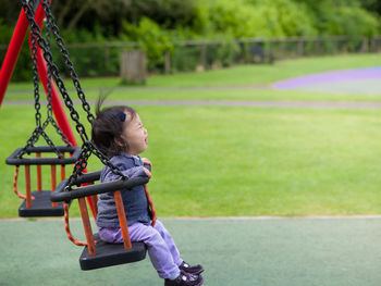 Young girl on swing at park