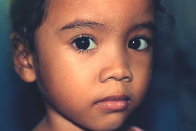 Close-up portrait of cute girl at home