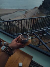 Cropped hand of woman drinking water