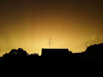 Low angle view of silhouette building against sky at sunset