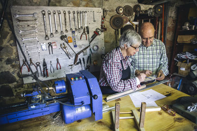 Senior man and woman working in workshop