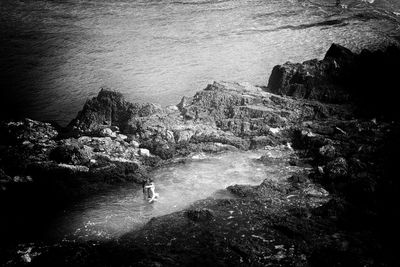 High angle view of sea by cliff