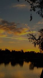 Scenic view of calm lake at sunset