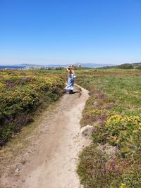 Full length of person on land against clear blue sky