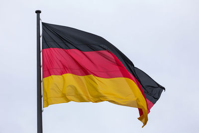 Low angle view of german flag against clear sky