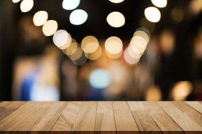 Defocused image of illuminated lights on table