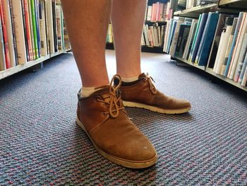 Low section of person on book at home