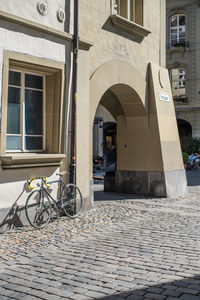 Bicycle on street against building