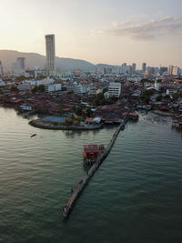 River amidst buildings in city against sky