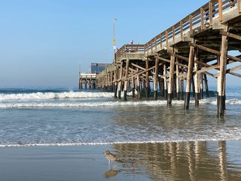 Pier over sea against clear sky