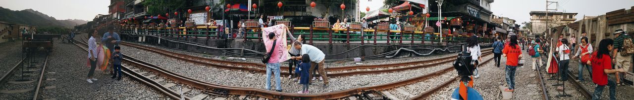 building exterior, architecture, built structure, multi colored, city, transportation, outdoors, panoramic, day, no people, cultures, travel destinations, in a row, colorful, abundance, clear sky, travel, incidental people, mode of transport, art and craft