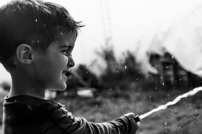 Close-up portrait of boy looking away outdoors