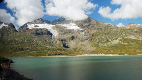Scenic view of lake and mountains against sky