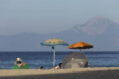 People on beach against sky