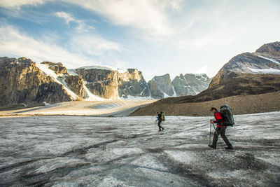 Side view of two mountaineers exploring auyuittuq national park