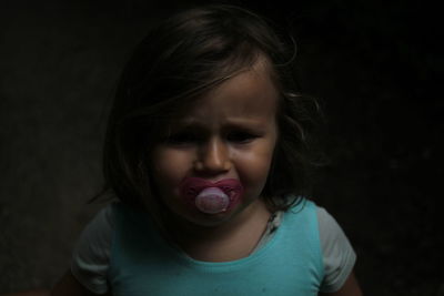 Close-up of girl with pacifier in mouth