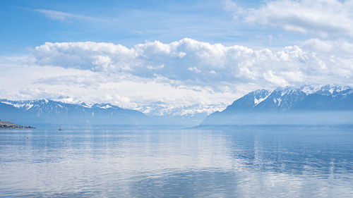 Scenic view of sea and mountains against sky