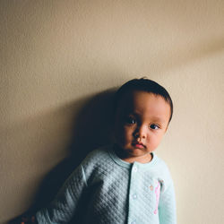 Close-up portrait of cute boy at home