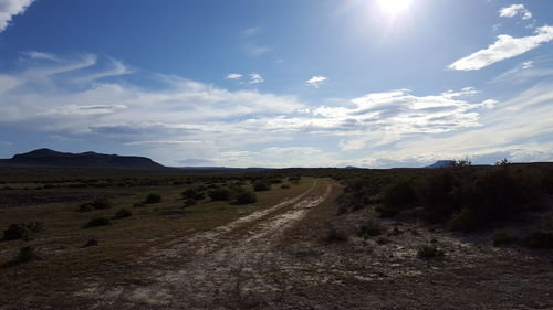 Scenic view of landscape against cloudy sky