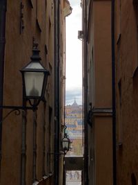 Street light amidst buildings seen through window