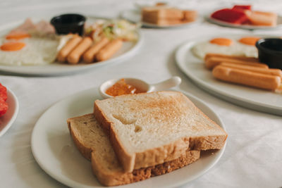 Hotel complimentary breakfast served on white bed.