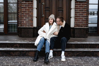 Portrait of young man sitting on steps