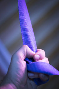 Cropped hand holding strap in gym