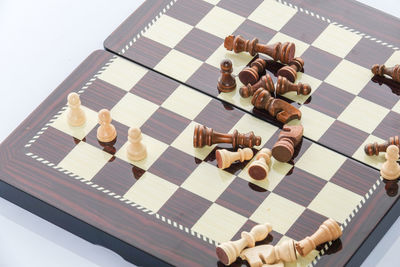 High angle view of chess board over white background