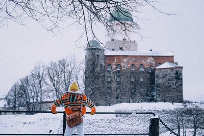 Rear view of man on snow covered landscape