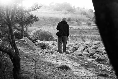 Rear view of man standing on landscape