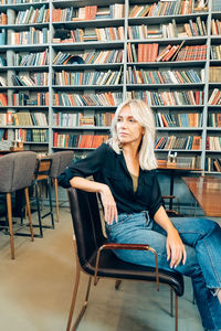 Young woman sitting on book