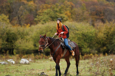 Horse riding horses on field