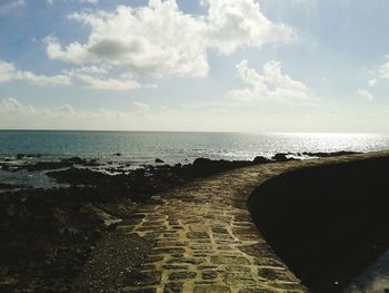 Scenic view of sea against cloudy sky