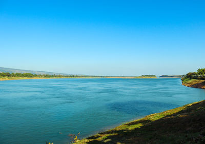 Scenic view of sea against clear blue sky