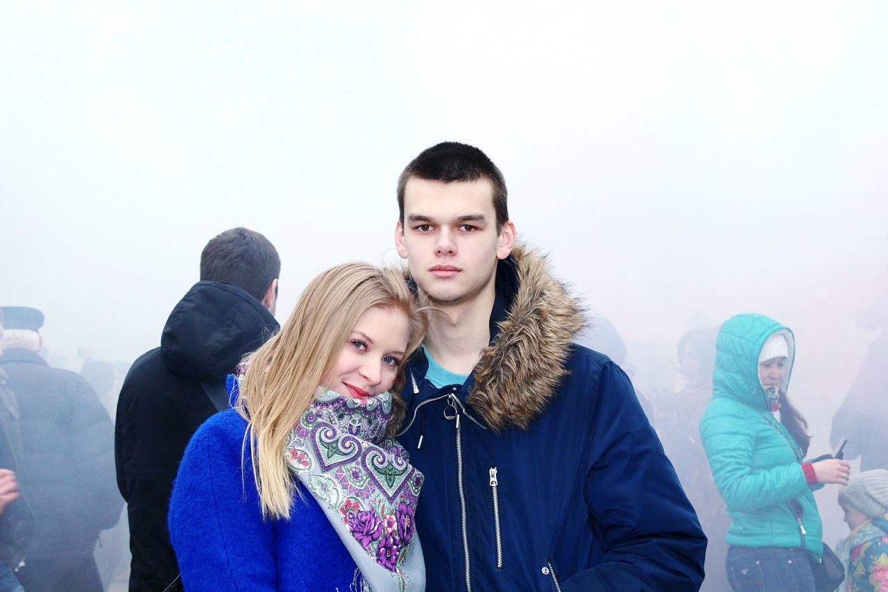 PORTRAIT OF YOUNG COUPLE STANDING AT SNOW