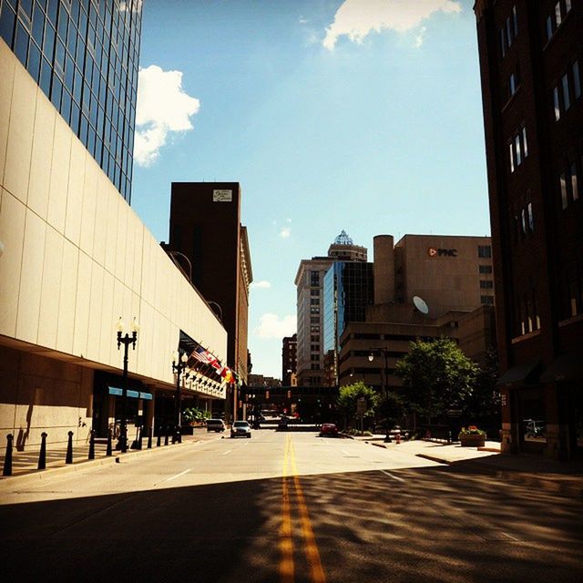 building exterior, architecture, built structure, city, office building, skyscraper, sky, modern, building, street, tall - high, tower, city life, the way forward, sunlight, road, day, outdoors, incidental people, cloud