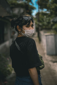 Portrait of young woman standing outdoors