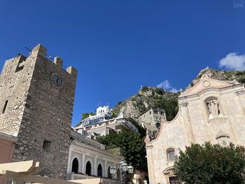 Low angle view of historic building against clear blue sky