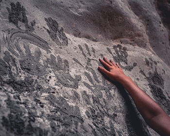 Close-up of hand on rock