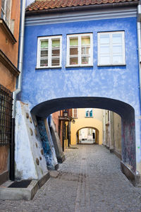 Empty alley amidst buildings in city