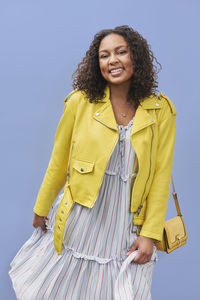 Portrait of a smiling young woman standing outdoors