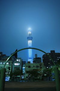 Low angle view of city lit up at night