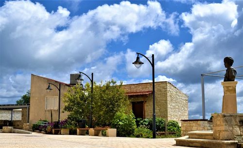 Low angle view of street and buildings against sky