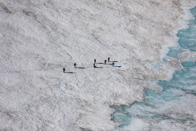 Aerial view of people on snow covered mountain