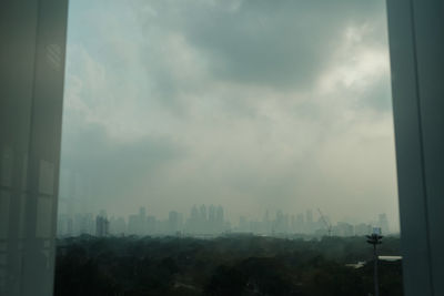 Panoramic view of buildings in city against sky