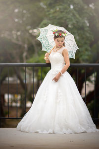 Woman standing on white umbrella