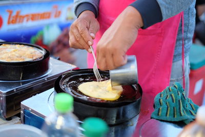 Close-up of man preparing food